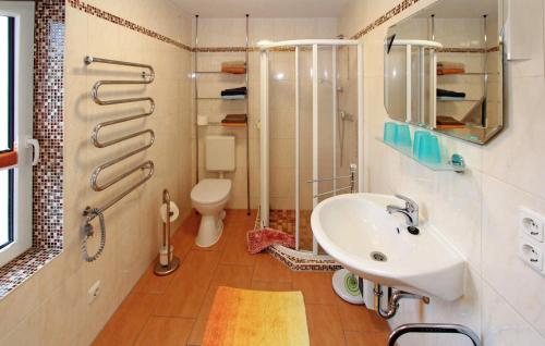 La salle de bains est pourvue d'un lavabo, d'une douche et de toilettes. dans l'établissement Amazing Home In Zinnowitz seebad With Kitchen, à Zinnowitz