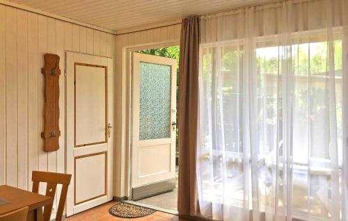 a room with a sliding glass door and a table at Fh Maisgelb in Warenthin