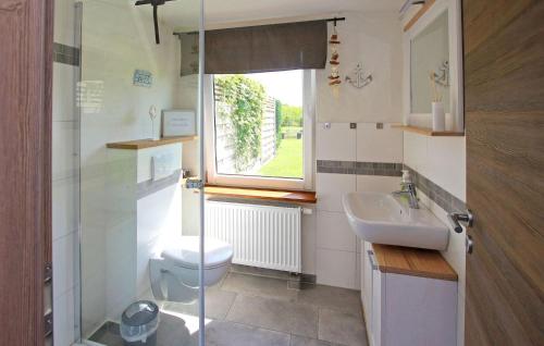 a bathroom with a toilet and a sink and a window at Stunning Home In Mirow Ot Starsow With Kitchen in Starsow