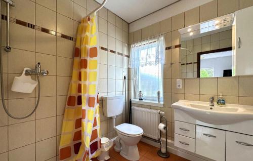 a bathroom with a toilet and a sink and a shower at 1 Bedroom Stunning Home In Klink in Klink