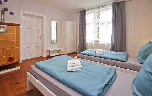 a bedroom with two beds and a window at Beautiful Home In Woldegk With Kitchen in Woldegk