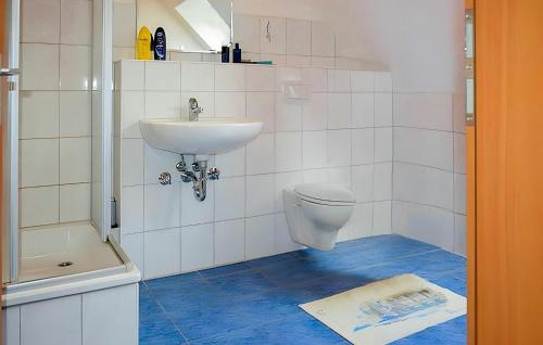 a bathroom with a sink and a toilet at Beautiful Apartment In Ostseebad Breege Ot Ju With Kitchen in Drewoldke