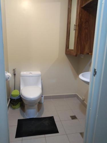 a bathroom with a toilet and a sink at Atria T3 Unit 624 Pool View in Iloilo City