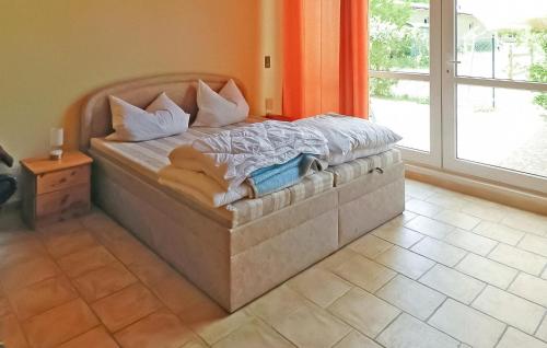 a large bed in a room with a window at Pet Friendly Apartment In Boitzenburger Land Ot With Kitchen in Rosenow