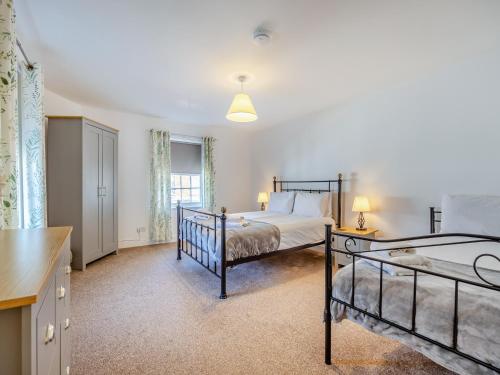 a bedroom with two beds and a kitchen at The Old Jolly in Wainfleet All Saints