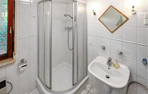 een witte badkamer met een douche en een wastafel bij Cozy Home In Dahmen With Sauna in Dahmen