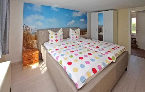 a bedroom with a large bed with polka dot sheets at Cozy Home In Hoffelde With Wifi in Blankensee
