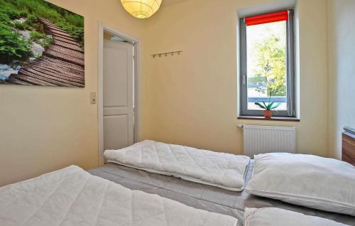 1 dormitorio con 2 camas y ventana en Cozy Home In Waren mritz With Wifi en Waren