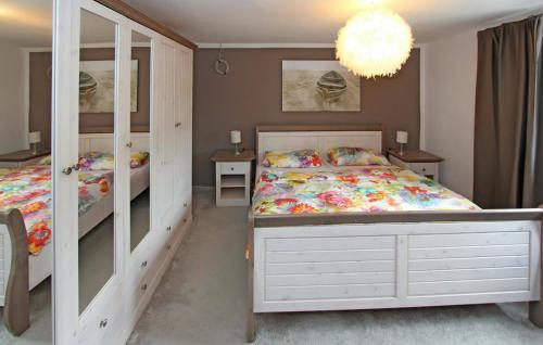 - une chambre avec 2 lits et un lustre dans l'établissement Stunning Apartment In Graal-mritz ostseehe With Wifi, à Graal-Müritz