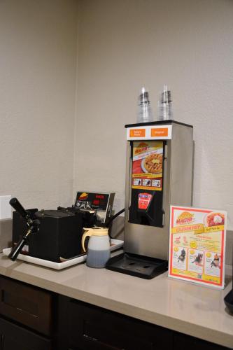 a machine sitting on top of a counter with a laptop at Comfort Inn & Suites Moreno Valley near March Air Reserve Base in Moreno Valley