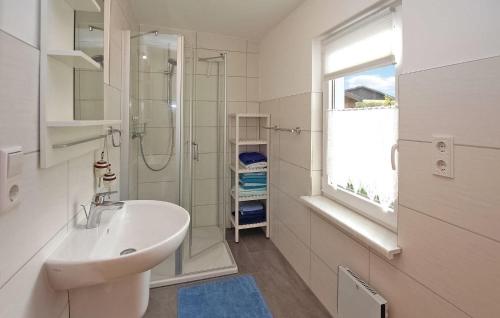 a white bathroom with a sink and a shower at 1 Bedroom Nice Home In Kummerow in Kummerow