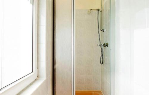 a shower with a glass door in a bathroom at Lovely Apartment In Rheinsberg Ot Kagar With Kitchen in Kagar