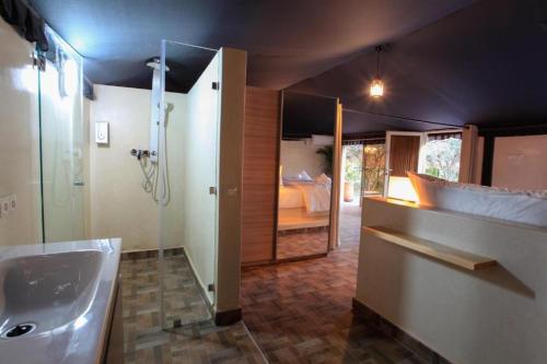 a bathroom with a tub and a sink and a shower at THE FARM LODGES & Private pool in Marrakech