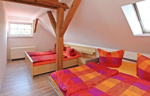 a room with two beds in a room with a attic at 3 Bedroom Cozy Home In Blankensee Ot Watzkend in Blankensee