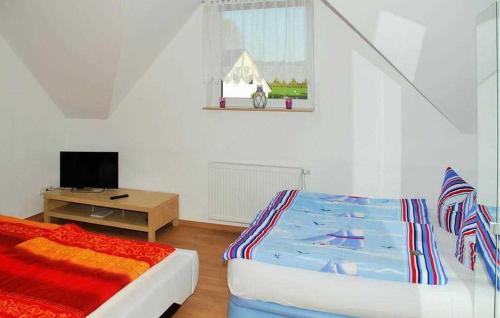 a bedroom with a bed and a tv in it at Nice Apartment In Neppermin-usedom With Kitchen in Neppermin