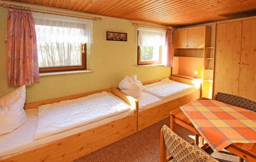 a room with two beds and a table and a window at Amazing Home In Rheinsberg Ot Kagar With Wifi in Kagar