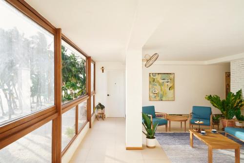 a living room with blue chairs and a table at Seaworthy Boracay in Boracay