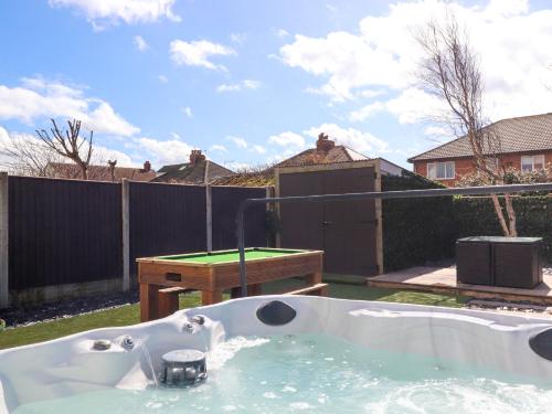 a bath tub with a ping pong table in a backyard at 19 Slinger Road in Cleveleys