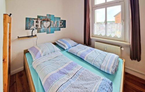 a bedroom with two beds with pillows and a window at Awesome Apartment In Wesenberg With Wifi in Wesenberg