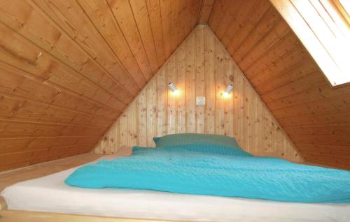 a bed in a room with a wooden ceiling at Nice Apartment In Dierhagen ostseebad With Wifi in Neuhaus