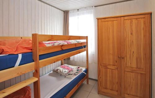 a bedroom with two bunk beds and a closet at Fh Brombeere in Warenthin