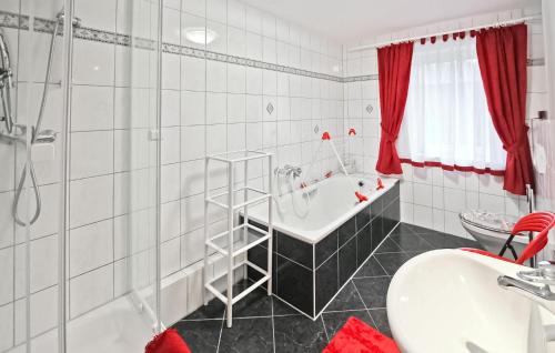 a white bathroom with a tub and a sink at 2 Bedroom Beautiful Home In Wokuhl-dabelow in Wokuhl