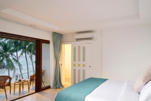 a bedroom with a bed and a view of the ocean at Seaworthy Boracay in Boracay