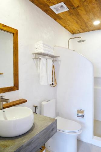 a white bathroom with a sink and a toilet at Seaworthy Boracay in Boracay