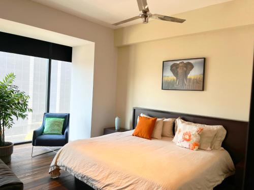a bedroom with a bed and a blue chair at Beguest Juarez Mrb&b Partner, King Size Gym in Mexico City