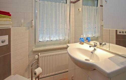 a white bathroom with a sink and a window at Amazing Home In Blankensee Ot Wanzka With Kitchen 