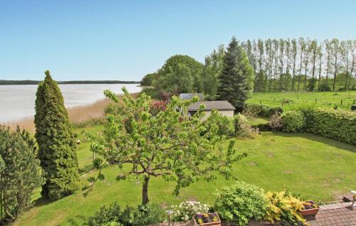 an aerial view of a garden with a house and a lake at Amazing Home In Torgelow Am See With Lake View in Torgelow am See