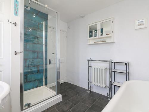 a bathroom with a shower and a sink at Kilden Cottage in Helston