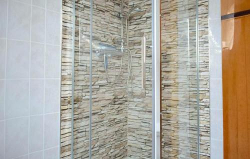 a bathroom with a shower with a stone wall at Gorgeous Apartment In Schwarzenhof With Wifi in Schwarzenhof