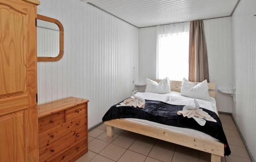 a bedroom with a bed with white pillows and a window at Fh Rot in Warenthin