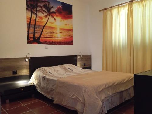 a bedroom with a bed and a painting on the wall at Sunrise Holidays in Porto Santo