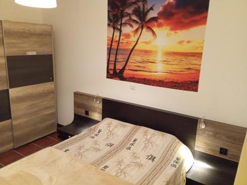 a bedroom with a bed and a picture of a beach at Sunrise Holidays in Porto Santo