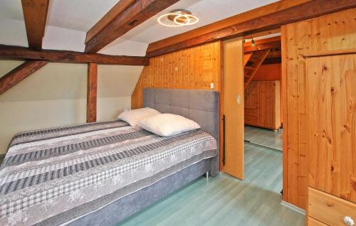 uma cama num quarto com paredes de madeira em Ferienwohnung Mit Charme em Burg Stargard