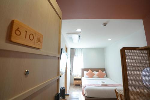 a small room with a bed and a couch at SO Zen Hotel Silom Bangkok in Bang Rak