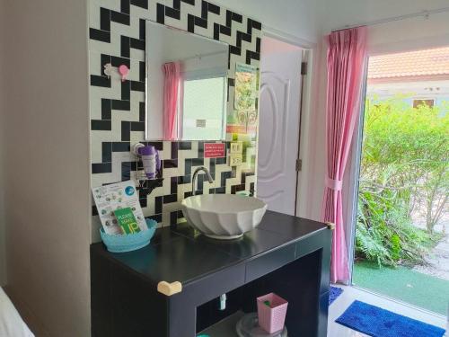 een badkamer met een wastafel en een spiegel bij Phannarai House in Lamai