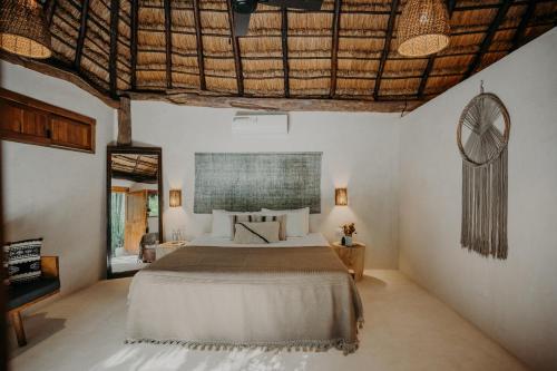 a bedroom with a large bed in a room at Sacred Hideaways in Tulum