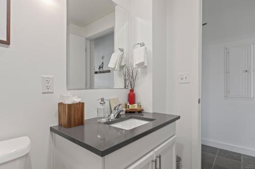 a white bathroom with a sink and a toilet at KBM Resorts: Modern 2BR Across from Deer Valley Gondola Pool Hot tub Ski Water skiing in Park City