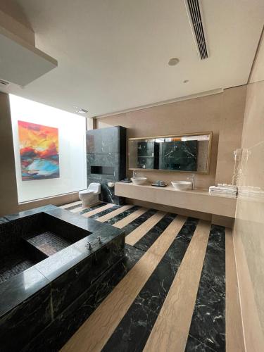 a large bathroom with two sinks and a large mirror at G.SHOCK Motel in Pingtung City
