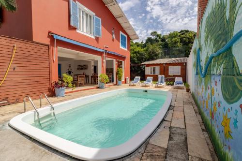a swimming pool in the backyard of a house at Hospedaria Conceitual in Florianópolis