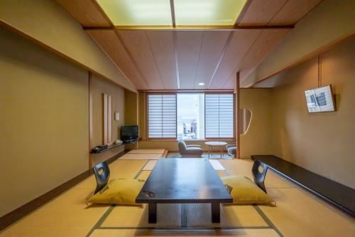 a conference room with a table and chairs in it at Kaike Tsuruya in Yonago