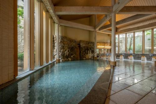 a pool in a building with a floor of water at Kaike Tsuruya in Yonago