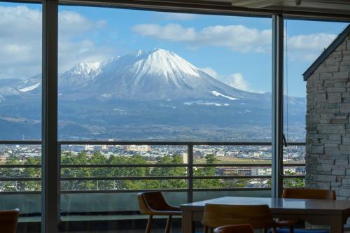 a view of a snow covered mountain through a window at Kaike Tsuruya in Yonago