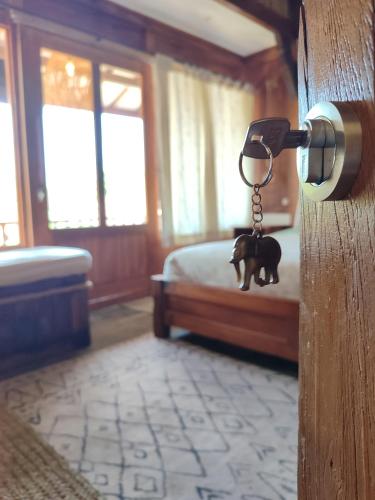 a room with a door with a key to a bed at Little Elephant Cottage in Gili Trawangan