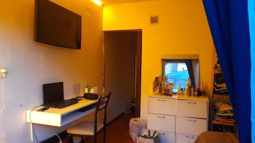 um quarto com uma secretária e um computador numa parede amarela em Departamento 2 H / Con balcón aterrazado em Morón