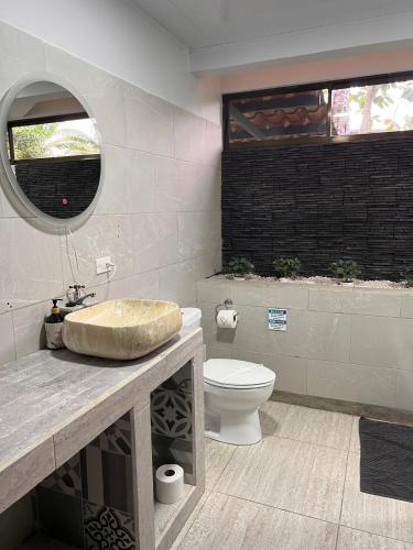a bathroom with a sink and a toilet at Residencias Arenal in Fortuna