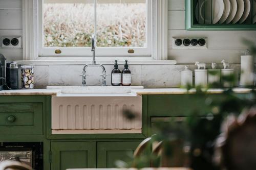 a kitchen with a sink and a window at Lake Daylesford Country House in Daylesford